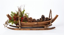 A Rustic Wooden Sled Adorned With Fir Tree Branches, Pinecones, And Holiday Decorations Against A Snowy White Backdrop.