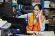 © offsuperphoto - factory worker speaking on the telephone and looking at computer monitor in the office or warehouse storage