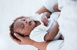 Top view of Close-up of cute African american newborn infant baby sleep in mother's hand at hospital. Healthcare medical. Black Mother hand lulling little child to sleeping. Newborn baby boy or girl.
