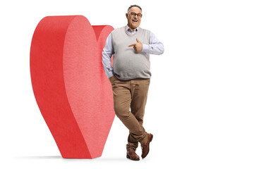 Canvas Print - Mature man leaning on a big red heart and pointing