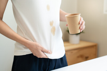 Wall Mural - Clothes stain dirty from food concept, people get a coffee drop split from glass on the t-shirt.