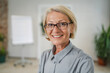 © Miljan Živković - Portrait of one mature blonde caucasian woman with eyeglasses indoor