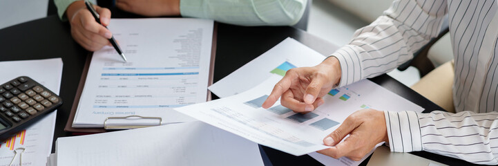 Wall Mural - Business woman analyzing data paperwork calculating numbers.