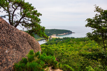 Wall Mural - Views hiking beehive loop in Acadia National park. Greenery, rocky coastline, and lakes, and Sand Beach, seen from a top the mountain.