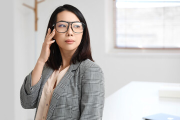 Canvas Print - Beautiful Asian businesswoman in stylish eyeglasses in office