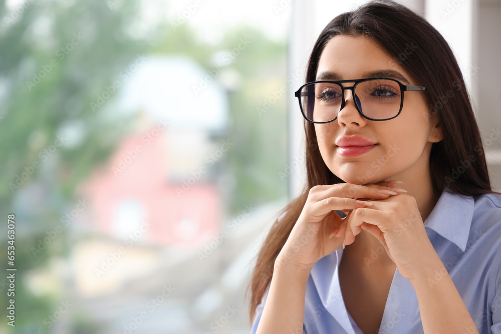 Beautiful young woman wearing glasses in office