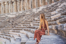 Woman Tourist Explores Aspendos Ancient City. Aspendos Acropolis City Ruins, Cisterns, Aqueducts And Old Temple. Aspendos Antalya Turkey. Turkiye