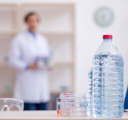 Wall Mural - Young male chemist experimenting in lab