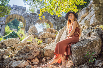 Wall Mural - Woman tourist explores Stunning Ancient Theater of Termessos Ancient City turkiye, GO Everywhere