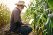 © VIX - farmer checking his corn data by laptop in farm before crop