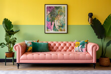 Long Pink Button Back Sofa With Colourful Floral Cushions Against A Green And Yellow Wall With Floral Picture Frame Wall Art Side Plant Pots With Tropical Green Leaves Minimalist Interior Room Design