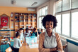 © Marko Geber - Portrait of a young African American elementary school teacher at her classroom