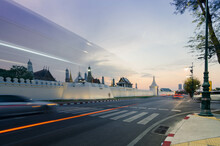 Street View At Grand Royal Palace Of Bangkok With Many Traffic In Long Expossure Light Tail Technique In Sunset With Beautiful Vanila Skytime.