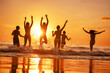 © cppzone - Group of happy young friends are having fun and runs to sunset sea beach over the waves