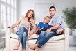 © BillionPhotos.com - Joyful happy young family with kids sitting at home, AI generated image