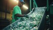 Garbage man working to recycle plastic bottle stack to conveyor line, garbage industry.