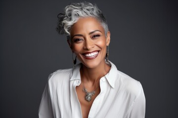 Wall Mural - photo of a profole of a 45-year-old African woman with a fashionable haircut in a plain blouse, eye contact, smile, dark background