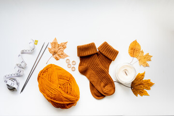 Set for knitting children's socks. Orange threads, knitting needles, buttons, centimeter.