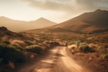 A Desolate Dirt Road Winding Through The Barren Desert Landscape
