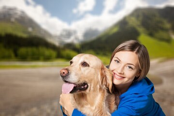 Canvas Print - a young happy woman plays with a dog