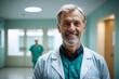 medium shot front view of old age male doctor with short blond hair in doctors outfit looking at camera while standing in the hospital, swedish, finnish, norwegian, danish, nordic, german, dutch.