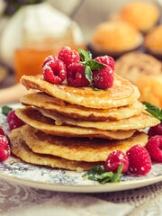 Wall Mural - Pile of sweet pancakes with berries and honey