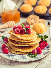 Wall Mural - Pile of pancakes with berries and honey on plate