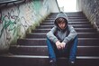 © bird_saranyoo - A boy sitting alone at stairs. Stress and mental problem in childhood ,Generative AI.