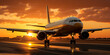 Commercial airplane taxiing in an airport runway at sunset - air transport concept