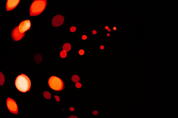 Wall Mural - red, lights and bokeh in a studio with dark background for celebration, event or party. confetti, gl