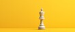 Yellow background with copy space and a queen chess piece representing a creative battle concept