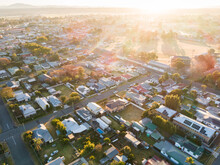 Housing Affordability Concept - Sunrise Over Residential Streets And Homes In Town