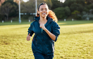 Canvas Print - Woman, running and training outdoor on field with smile, fitness and health in sunshine with vision at workout. Girl runner, exercise and happy for speed, wellness and thinking in summer on grass