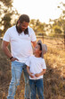 © Austockphoto - Happy aboriginal father with son in paddock smiling together