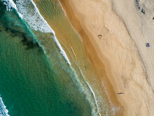 Green Sea Water With Golden Beach Sand From Overhead Aerial Perspective