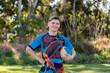 © Austockphoto - Smiling portrait of happy teenage Australian footy sports player holding football