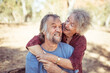 © Austockphoto - Happy elderly couple hug in the Northern Territory