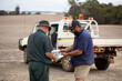 © Austockphoto - two men looking at map outdoors near work vehicle