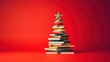 canvas print picture - Christmas tree made from pile of books. Colorful Books in the form of christmas tree on red background. Creative Chirstmas background in minimalist style. Holiday book sale, Christmas reading.