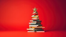 Christmas Tree Made From Pile Of Books. Colorful Books In The Form Of Christmas Tree On Red Background. Creative Chirstmas Background In Minimalist Style. Holiday Book Sale, Christmas Reading.