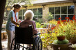 Tranquil Elderly Care: A Senior Woman in a Wheelchair Finds Comfort in the Nursing Home Garden, ai generative