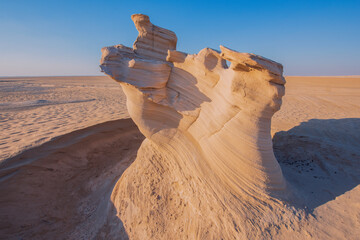 Wall Mural - Desert eroded rock pattern with clear sky during the sunset. Desert rock formation with erosion.