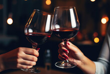 Friends Toasting With Glasses Of Red Wine At Bar, Close Up, Dark Background