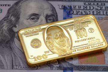 US 100 dollar golden bar die cut stamp on US 100 dollar banknote background