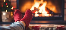 Feet In Woollen Socks By The Christmas Fireplace In Winter Time