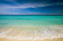 Clear Blue Water And Wispy Clouds Along The Beach At Cancun; Cancun, Mexico