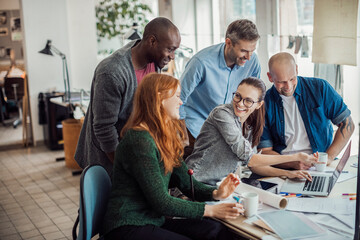 Group of people working together on a project in a startup company office