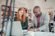 © Geber86 - Young man and woman working together on a project in a startup company office