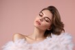 © Anatolii - Beautiful woman with soft feathers on pink background