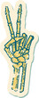 iconic distressed sticker tattoo style image of a skeleton giving a peace sign